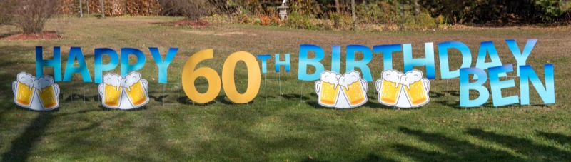 Happy Birthday sign on lawn with letters and graphics