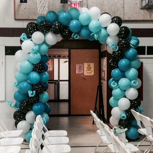 white, turquoise, and black balloon doorway arch