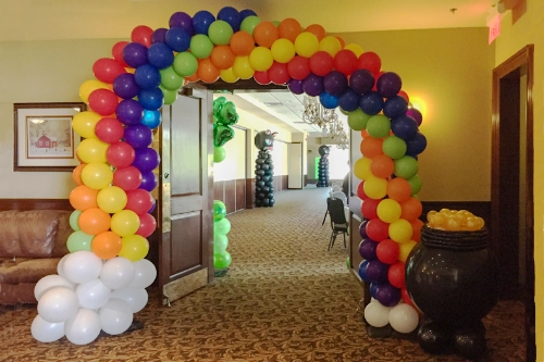 rainbow balloon arch in doorway