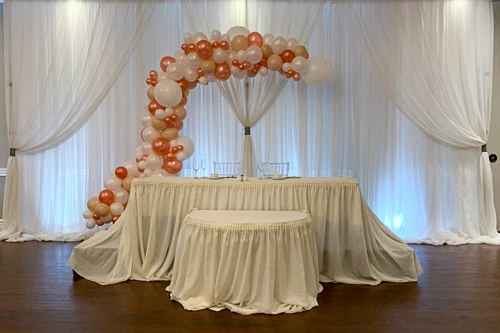 white and pink balloon organic arch and tables