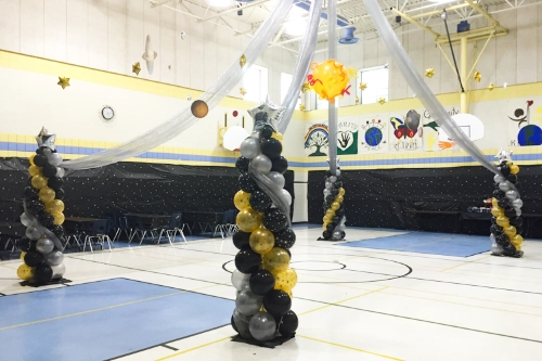 gold, black, and silver balloon columns in dance floor canopy