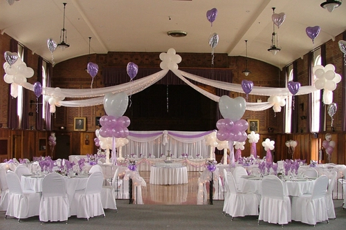 mauve and white wedding with organza, balloon decor, and white chair covers