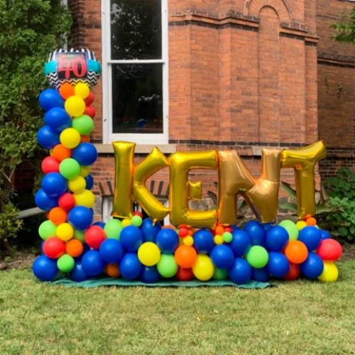 colourful balloon sculpture and name in gold foil balloon letters