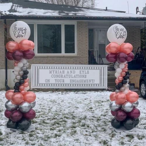 engagement announcement with silver, pink, and burgundy balloon columns