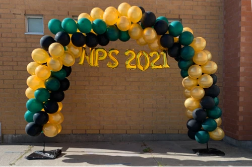 green, black, and gold arch for school graduation