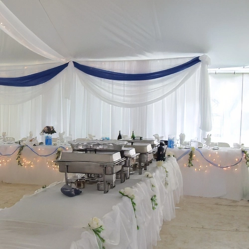 organza tent decor and chafing dishes on buffet table