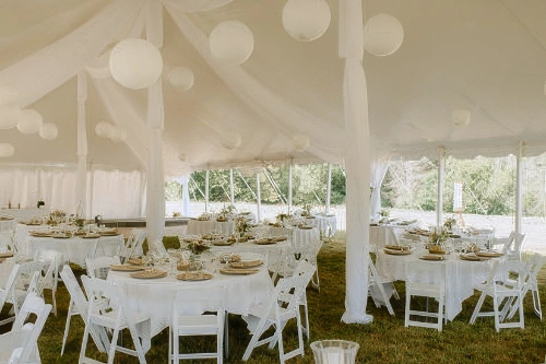 interior of tent set up with tables and decor
