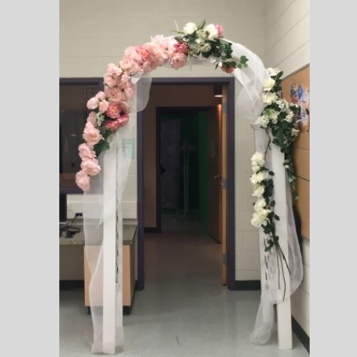 lattice arch decorated with pink and white flowers and organza